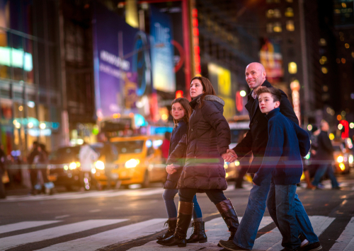 shutterstock_1287322099.jpg featured image A family crossing a busy street at night.