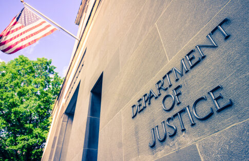 Department of Justice building with American flag.