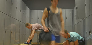 Men in a gym locker room preparing for a workout