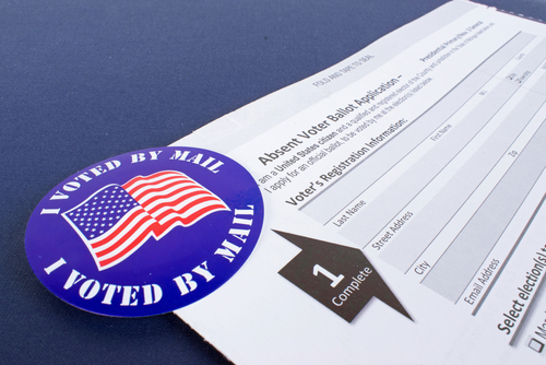 Mail-in ballot application with I Voted By Mail sticker.