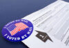 Mail-in ballot application with "I Voted By Mail" sticker.