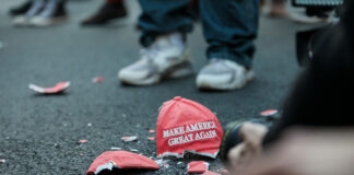 Broken Make America Great Again hat on the ground.
