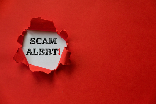 shutterstock_1906998922.jpg featured image Torn red paper revealing Scam Alert text underneath.