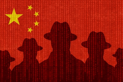 shutterstock_2139003467.jpg featured image Silhouettes with hats on a Chinese flag background.