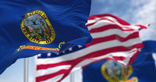 shutterstock_2163513925 (2).jpg featured image Idaho and U.S. flags waving in the wind.