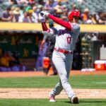 Baseball player swinging bat during a game.