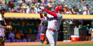 Baseball player swinging bat during a game.