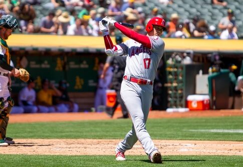 Baseball player swinging bat during a game.