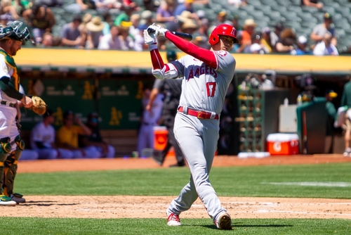 Baseball player swinging bat during a game.