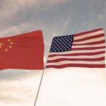 Chinese and American flags waving side by side.