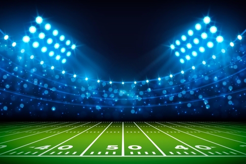 shutterstock_2200701739.jpg featured image Football stadium under bright lights at night.