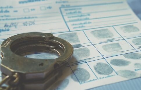 Handcuffs on a fingerprint form document.