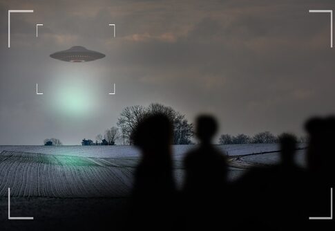 Silhouetted figures observing a UFO in a cloudy sky over a snowy field