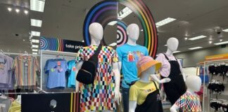 Pride-themed clothing display at a retail store.