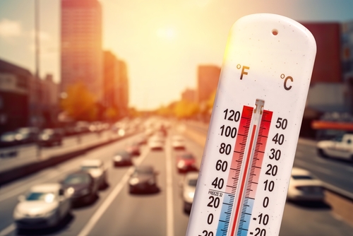 shutterstock_2327163719.jpg featured image Thermometer showing high temperature in busy city traffic.