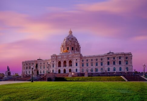 Minnesota State Capitol building at sunset with a colorful sky