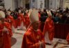 Cardinals in red robes and mitres participating in a religious ceremony