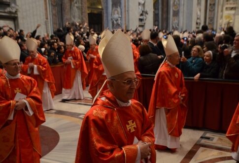 Cardinals in red robes and mitres participating in a religious ceremony