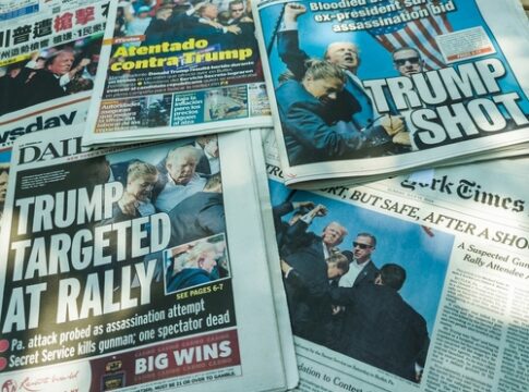 Newspaper headlines about an assassination attempt on Donald Trump.