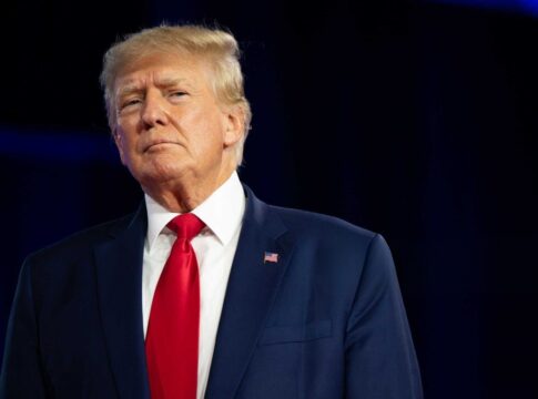 donald trump in suit with red tie standing