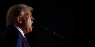 Man speaking into a microphone in the dark