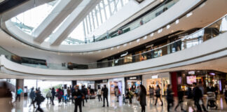 People walking inside a modern shopping mall.