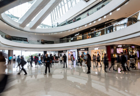 People walking inside a modern shopping mall.