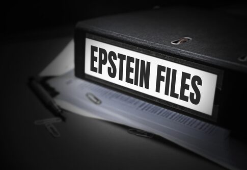 A black binder labeled 'EPSTEIN FILES' with papers and office supplies nearby