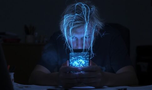 A young person intently looking at a smartphone with glowing effects around their head