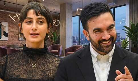 Two professionals engaged in conversation in a modern office setting