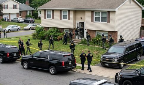 Law enforcement officers conducting a raid in a residential neighborhood