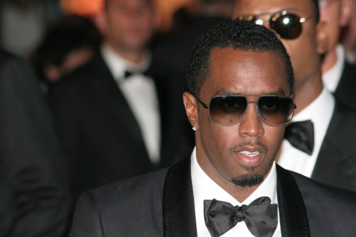 Man in suit and sunglasses at formal event