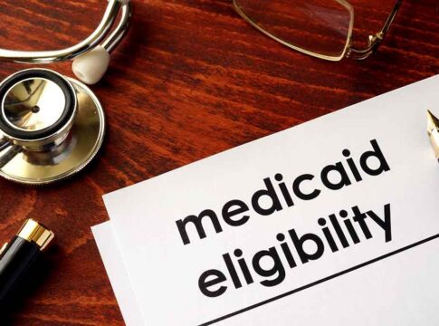 Medicaid eligibility form with stethoscope and pen on desk