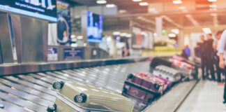 Suitcases on an airport baggage carousel.