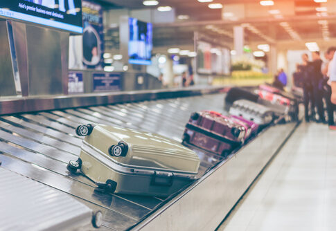 Suitcases on an airport baggage carousel.