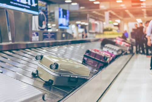 shutterstock_735367750.jpg featured image Suitcases on an airport baggage carousel.